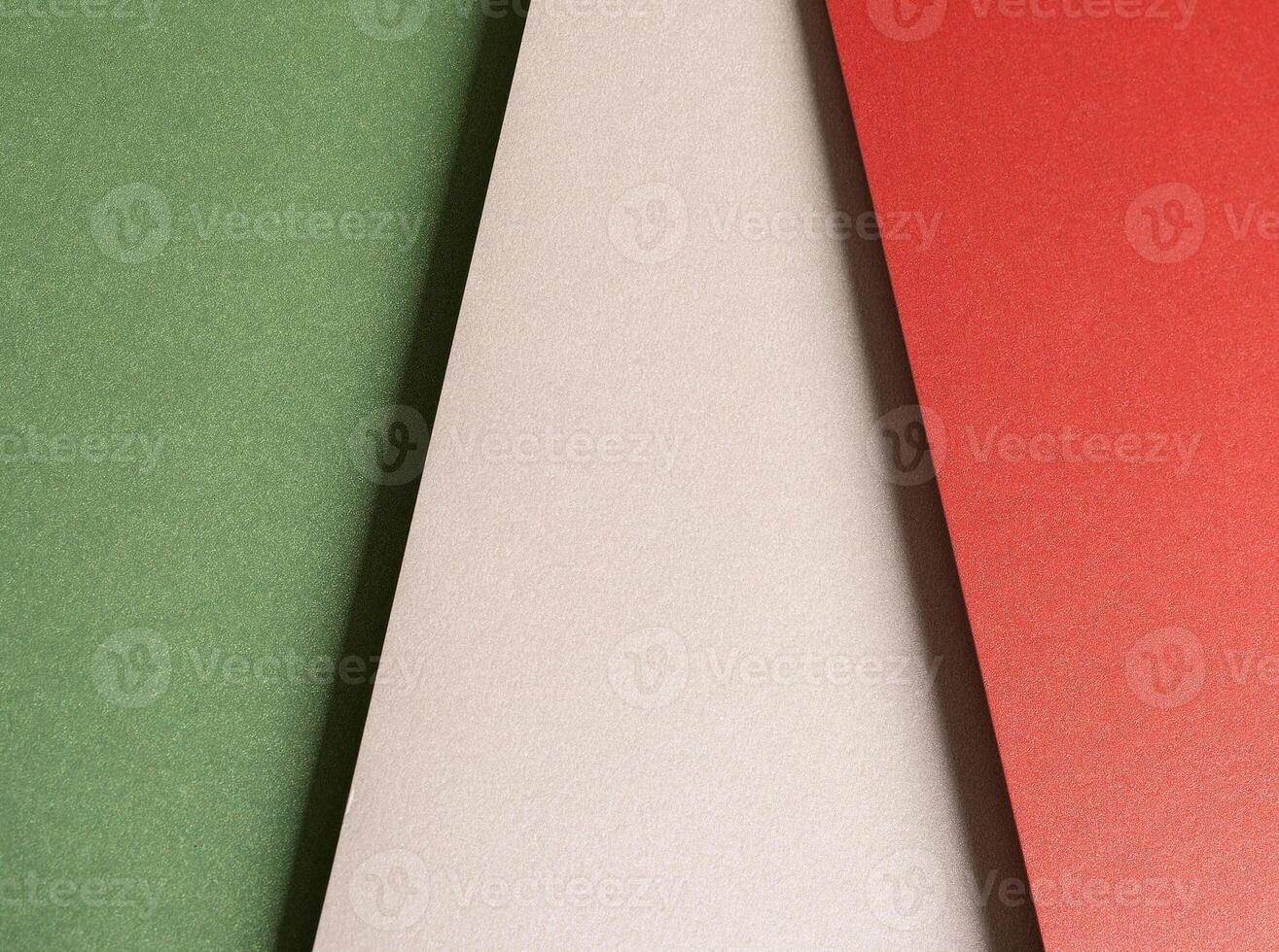 Paper background with matte texture. Vertical layered sheets in crimson red, pastel green, mint photo