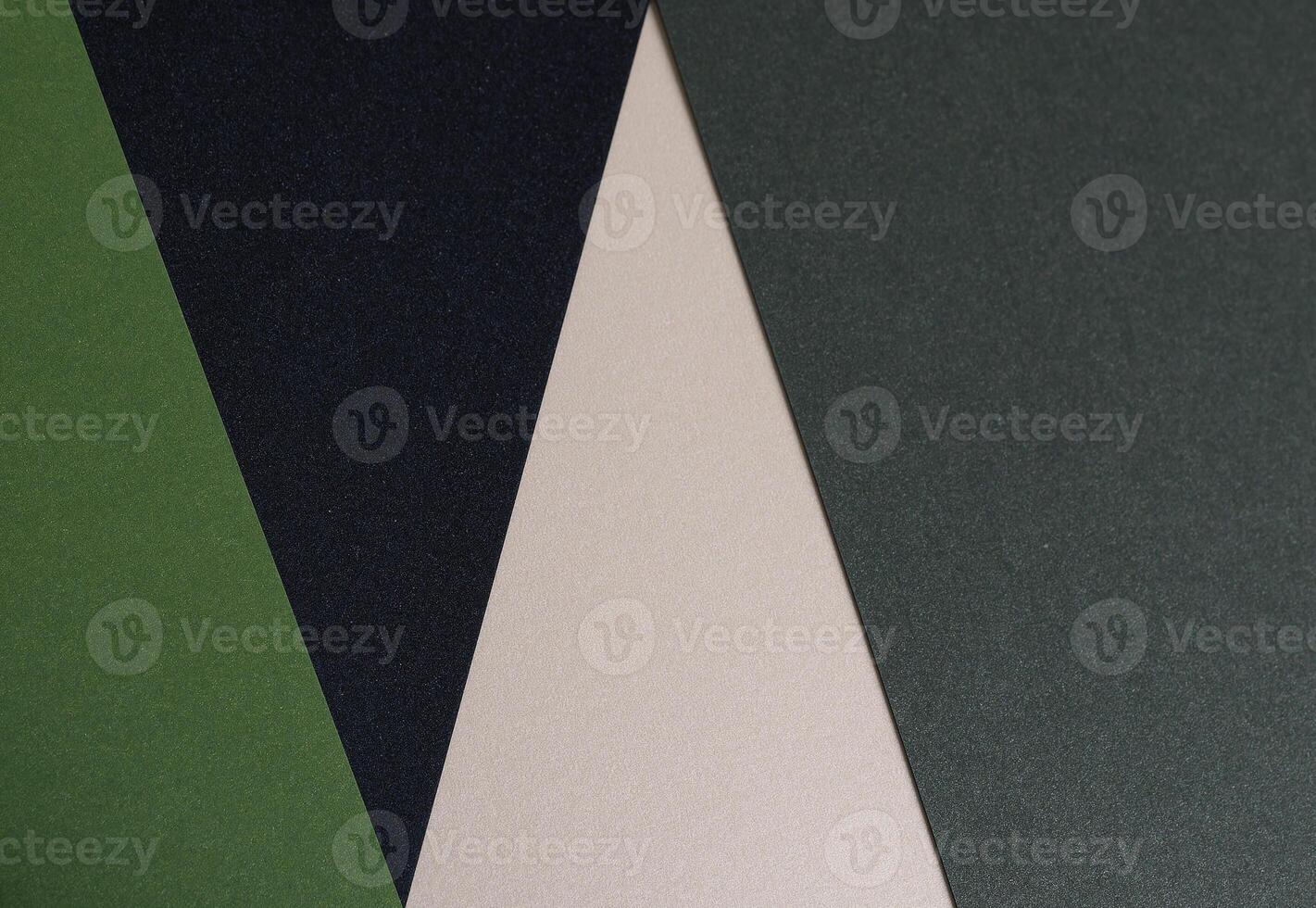 Paper background with matte texture. Layered diagonal sheets in pine green, mint green, champagne, photo