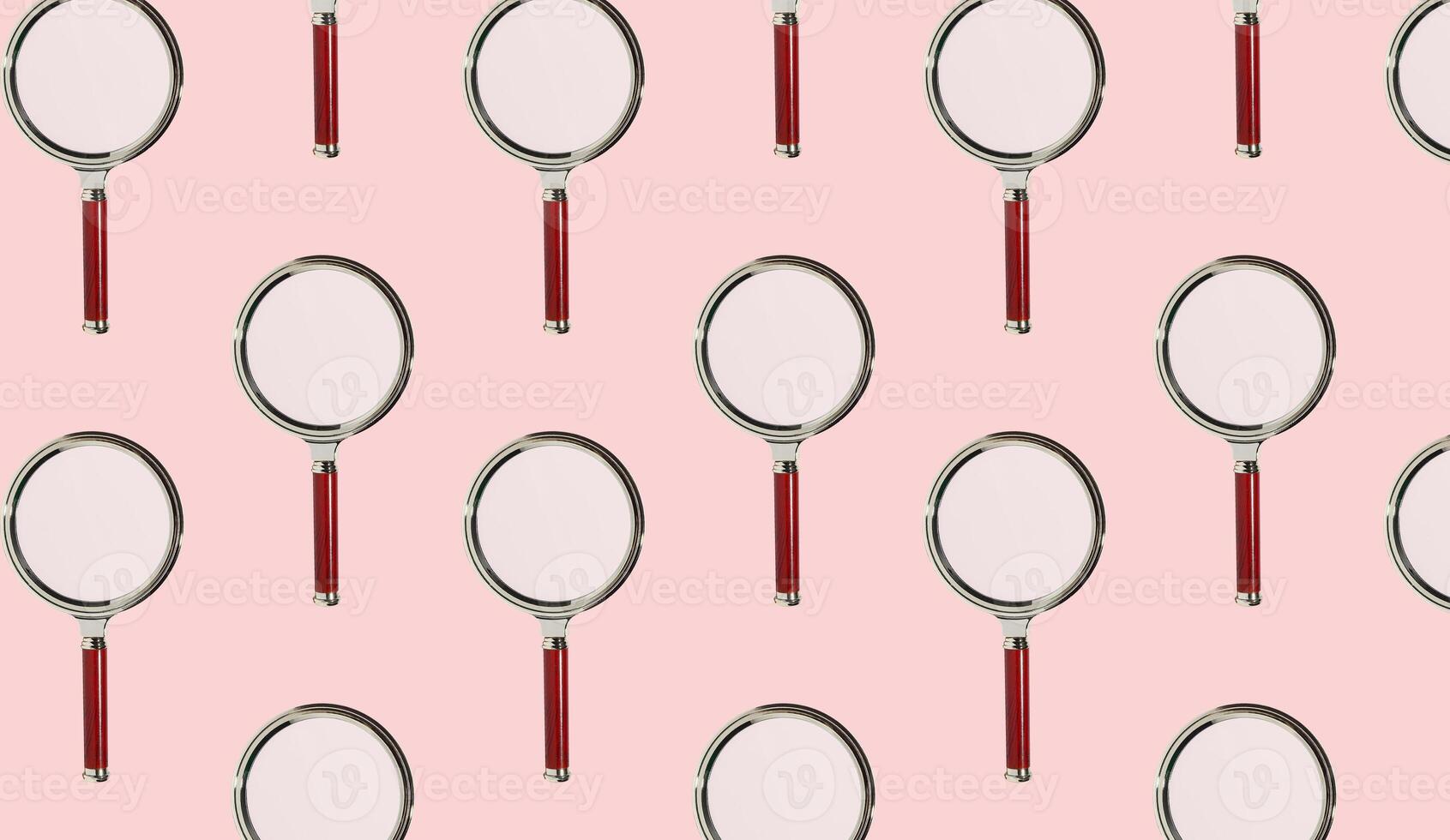Magnifying glasses arranged in a repeating pattern, symbolizing exploration, examination, and photo