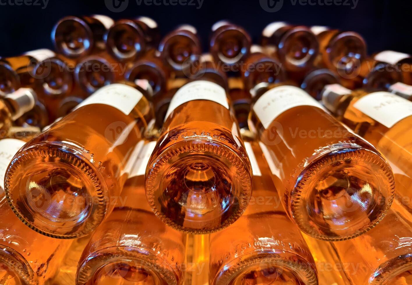 Many bottles of wine neatly arranged on a shop shelf photo