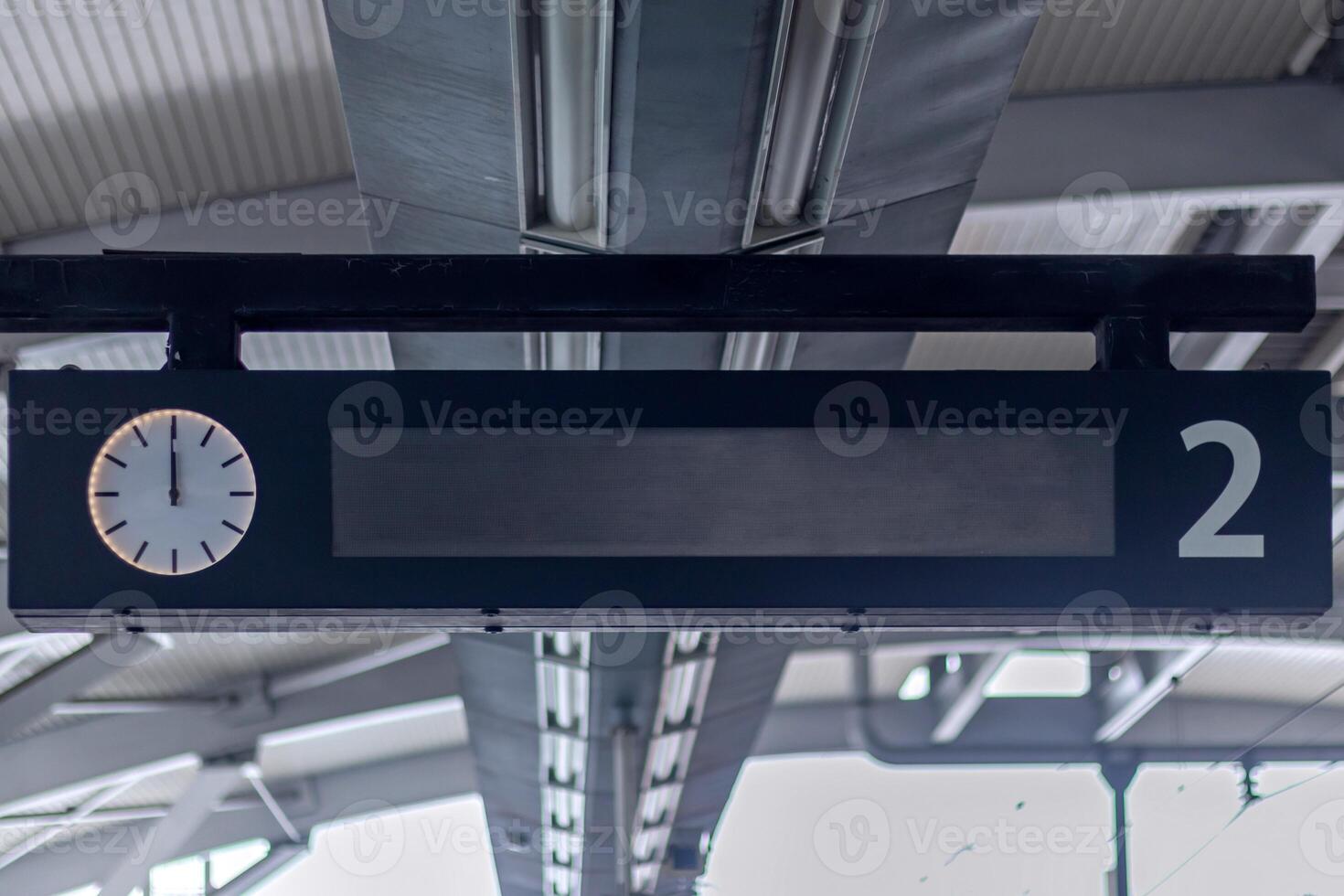 LED panel display with analog clock in the train station. Train Schedule Display. photo