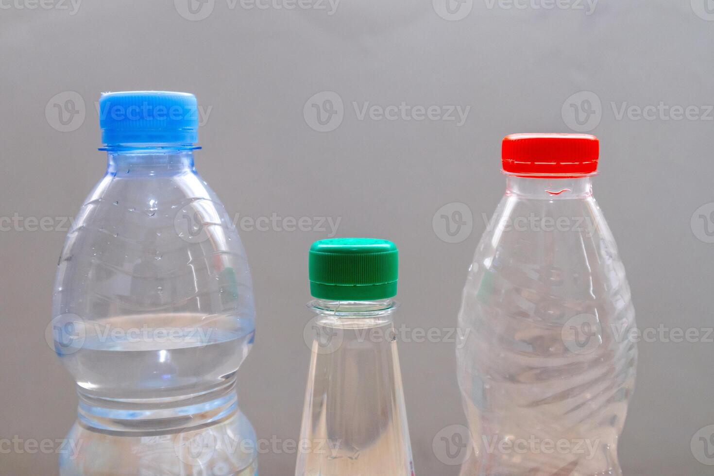 Plastic beverage bottles with different shapes and cap colors photo