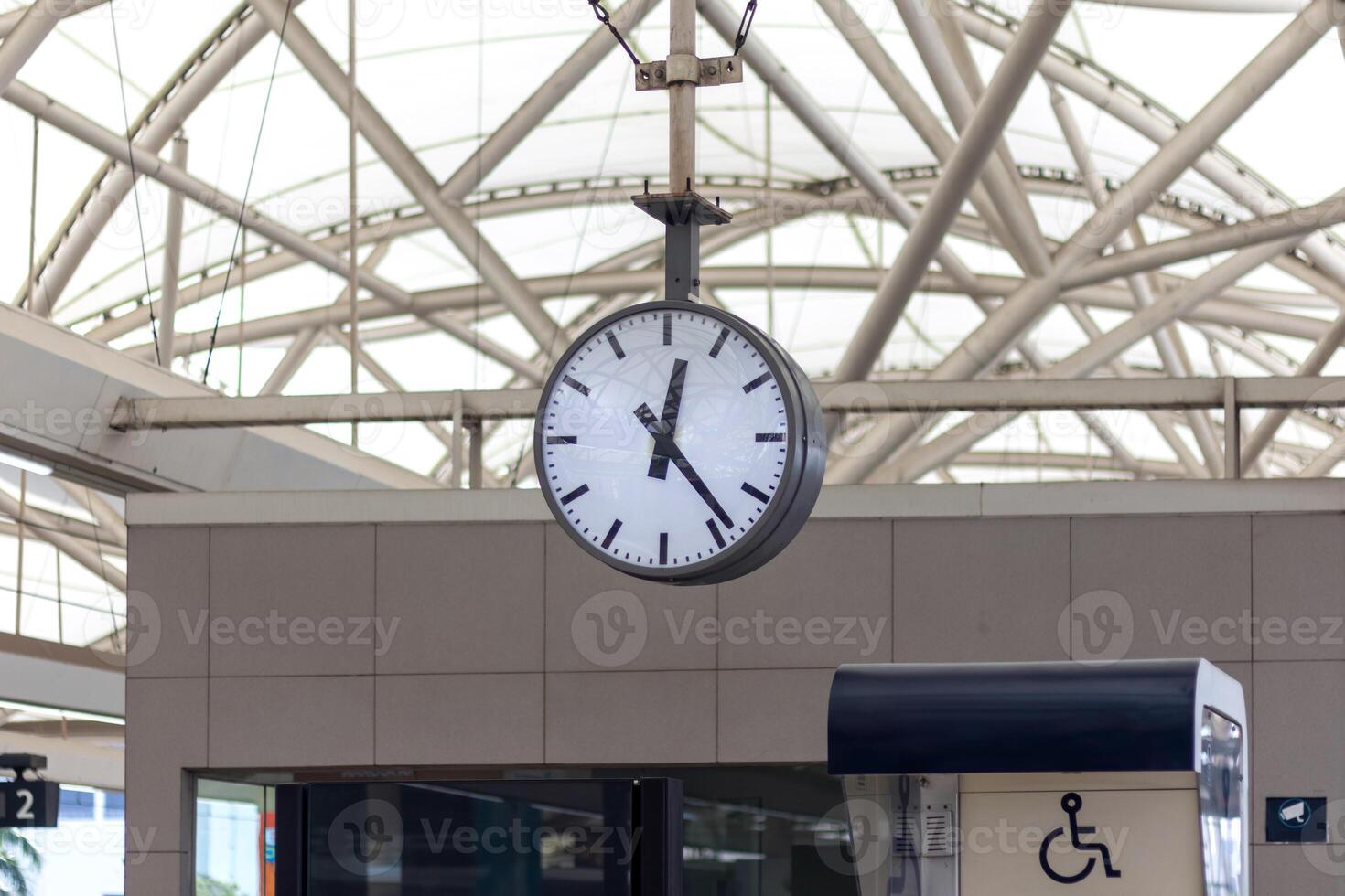 An analog clock hanging at the station photo