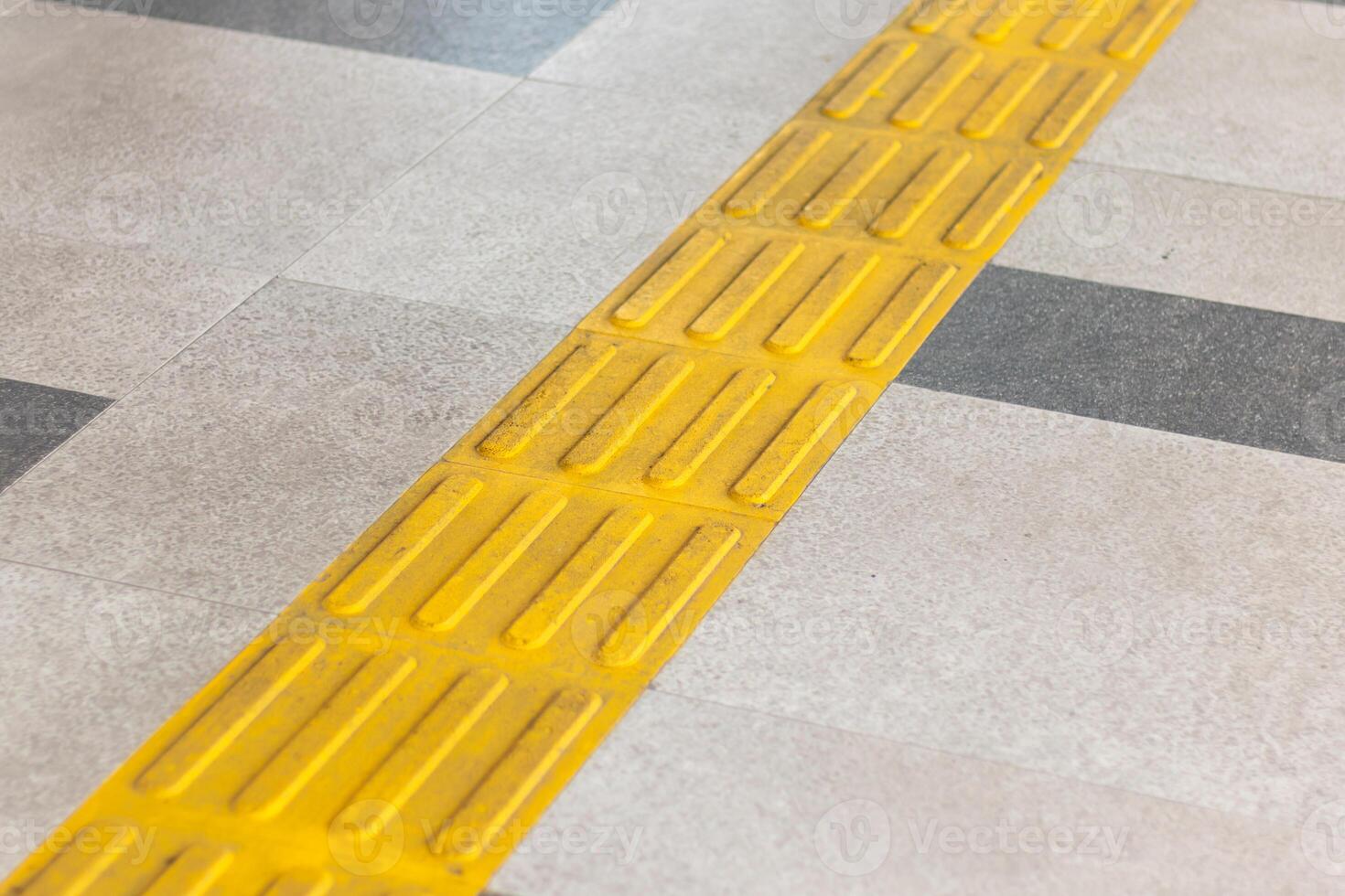 Pedestrian walkway with yellow guiding block brick photo