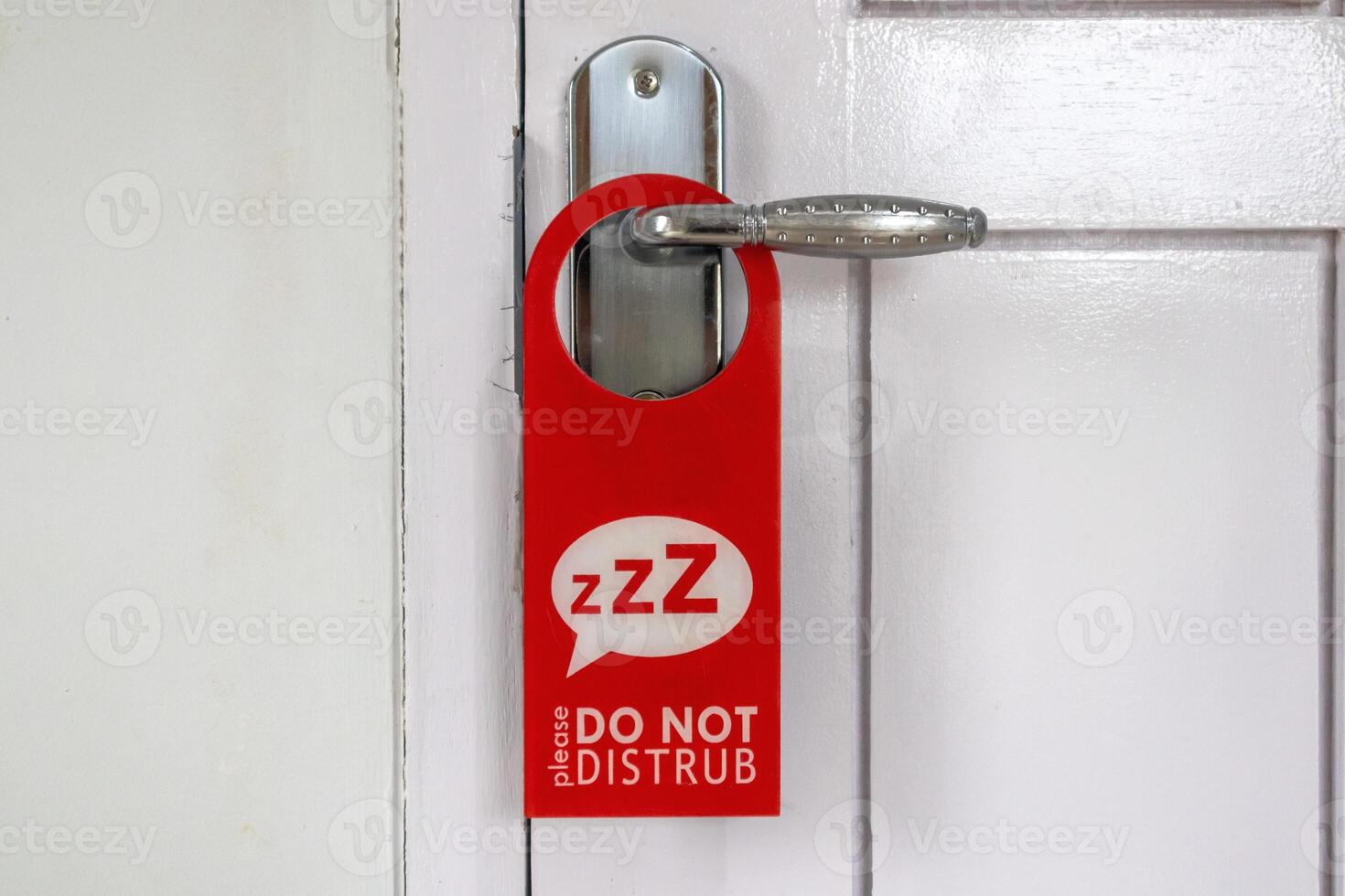 Do Not Disturb sign on hotel room's door photo