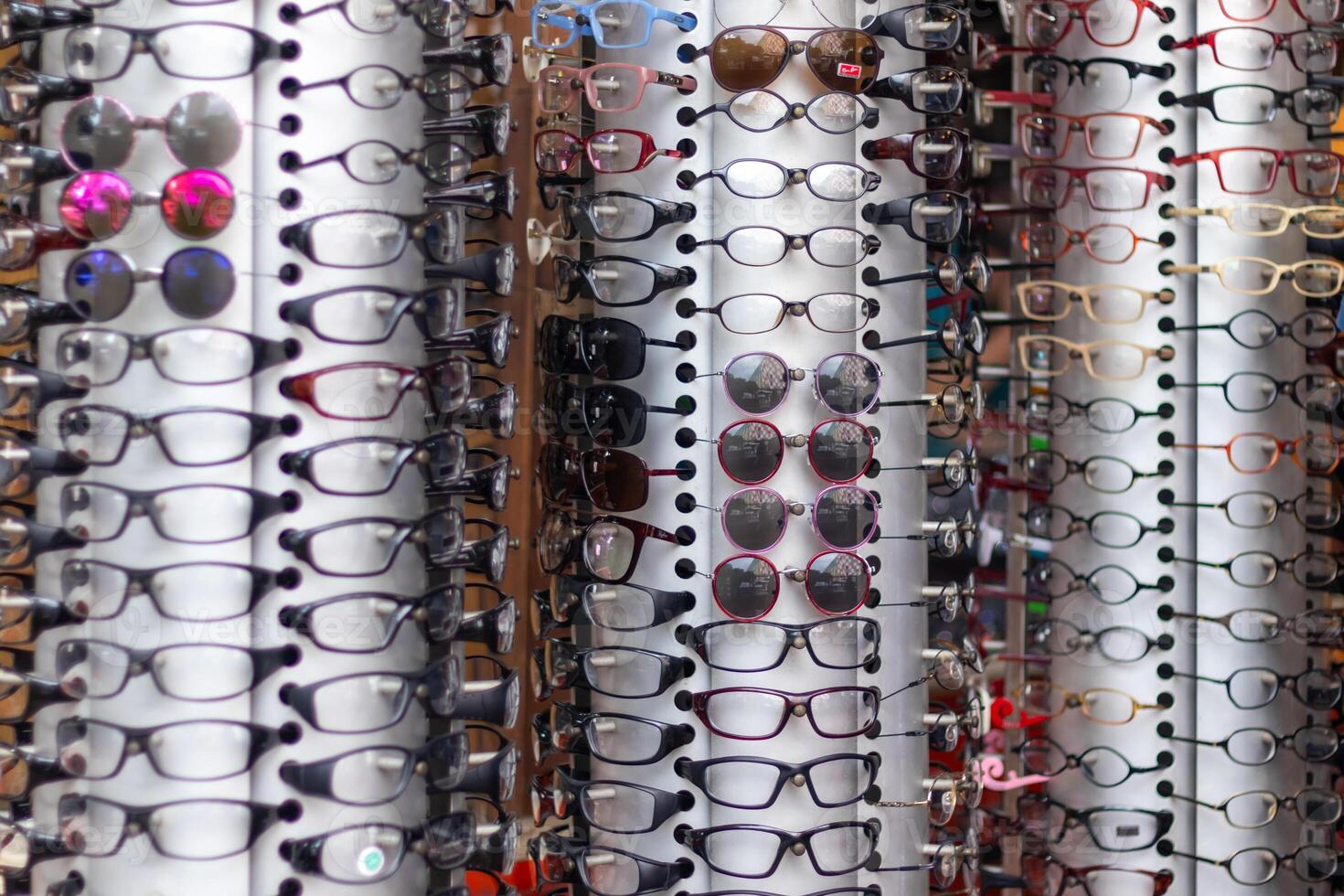 View of various kinds of sunglasses and fashion eyewear on display in an eyewear store photo