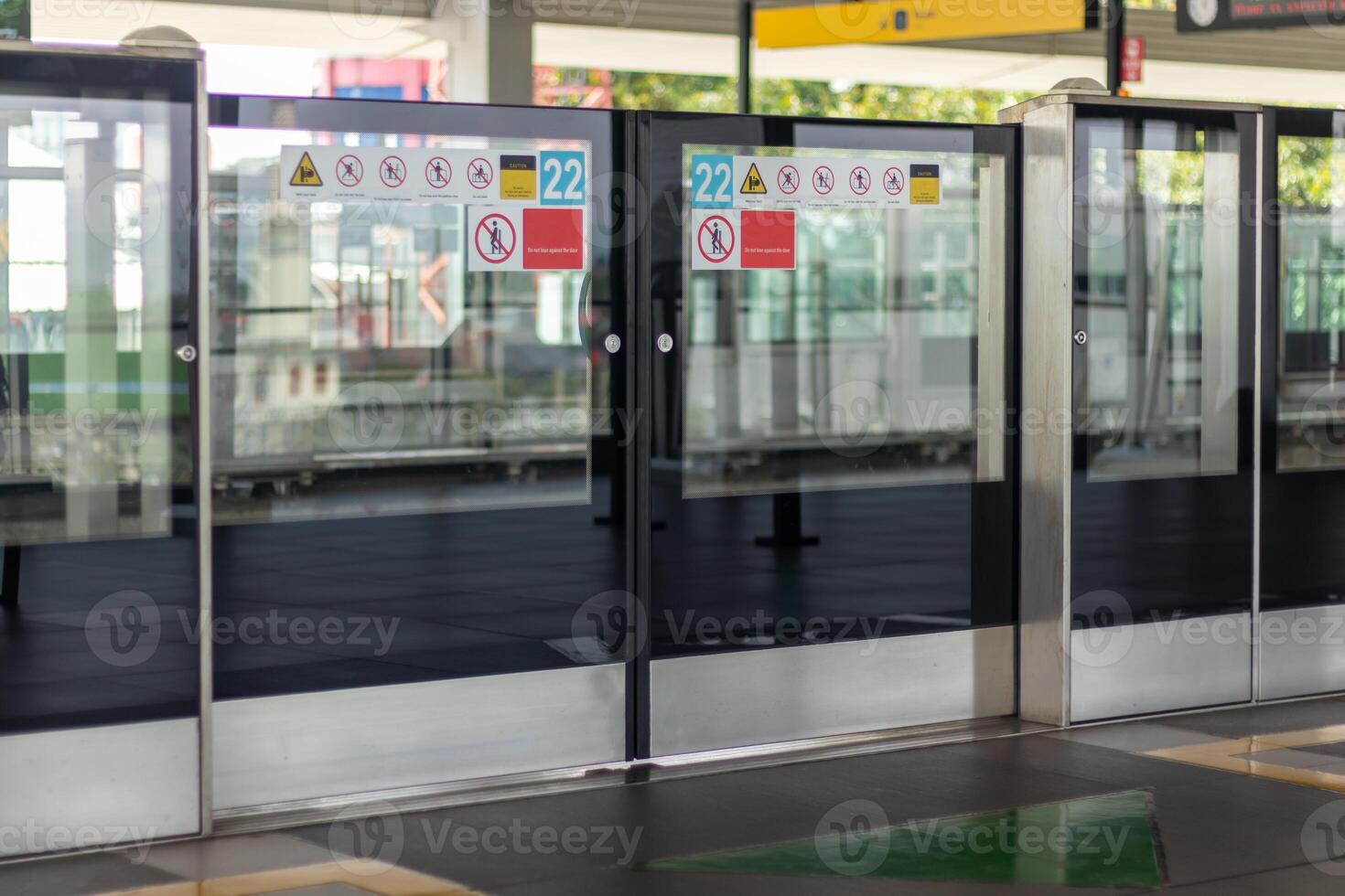 Platform Screen Door or Platform Edge Door with various safety warning stickers at the Mass Rapid Transit train station Jakarta photo