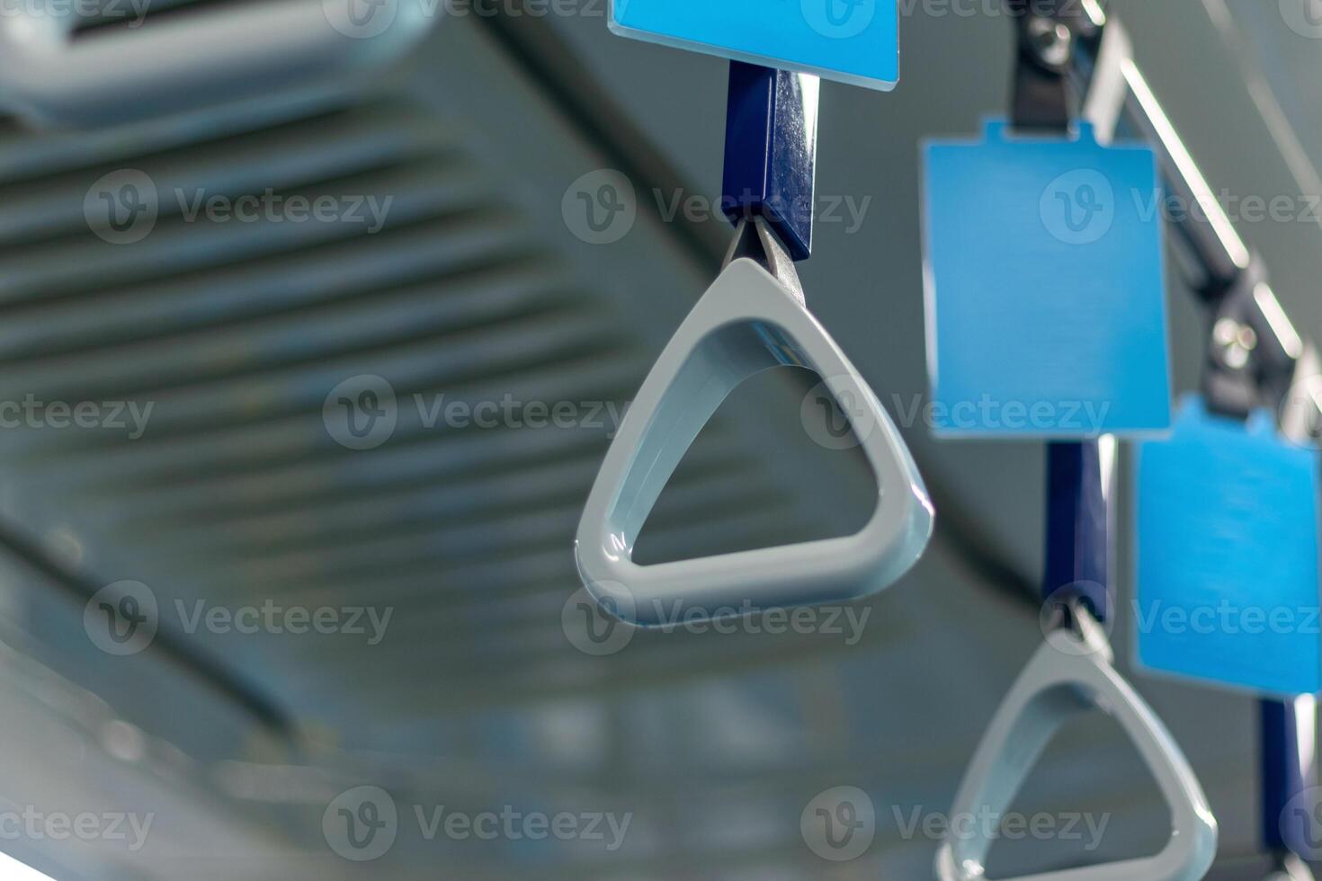 Hanging handle grip on public transportation with blank advertising banner photo