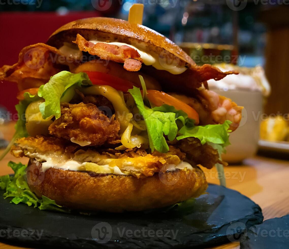 Close-up of a Pulled Pork and Bacon Burger on a table photo