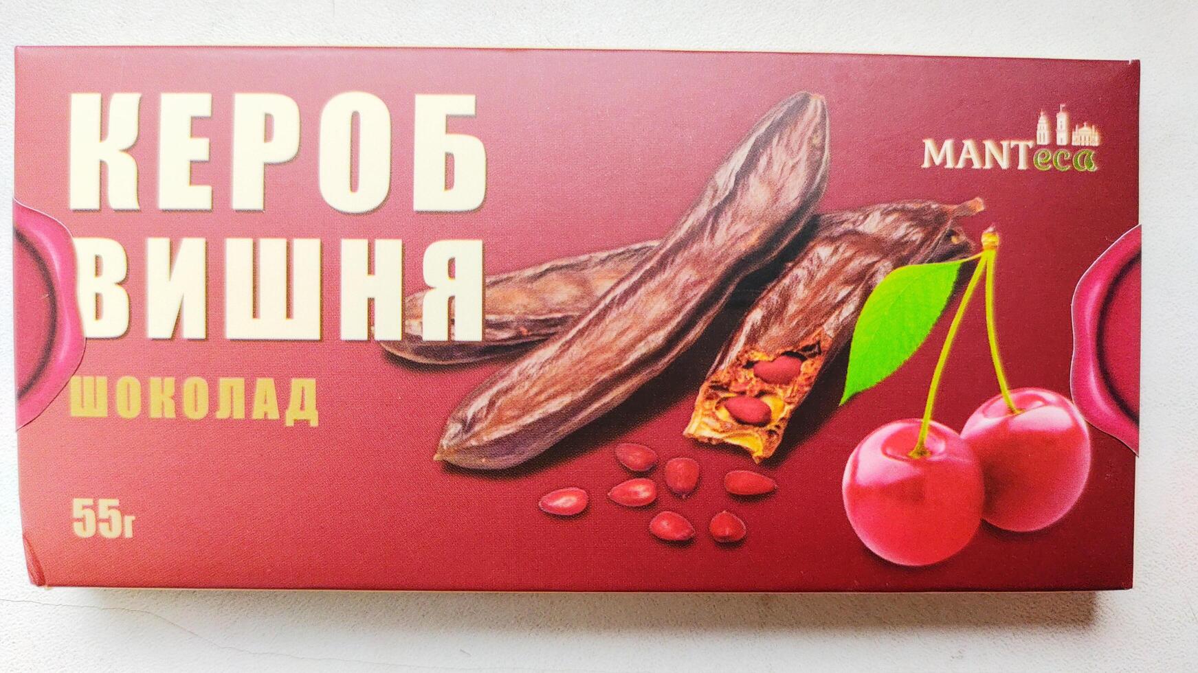 Dnipro, Ukraine - April 26, 2025 - Manteca cherry carob chocolate bar healthy alternative to cocoa in elegant red packaging. Concept of natural sweets, sugar free treat, vegan dessert option photo