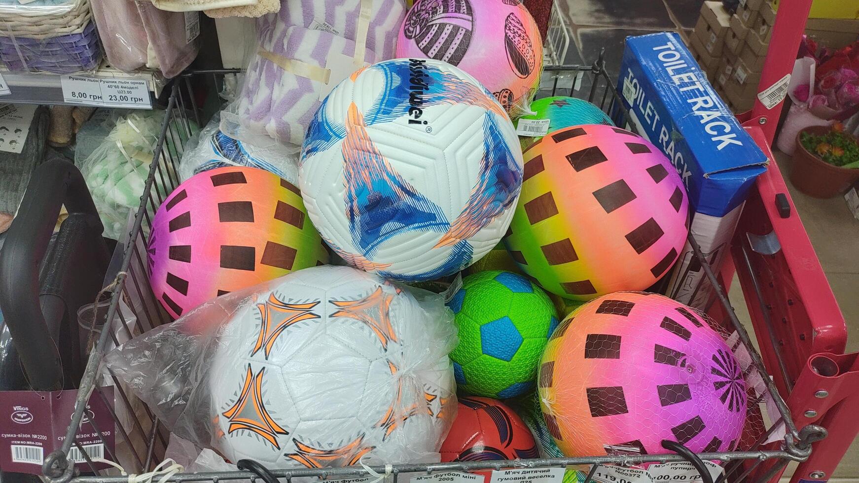Dnipro, Ukraine - April 26, 2025 - Colorful variety of inflatable balls on display in store rack. concept of sporting goods, indoor games, shopping for recreation supplies photo