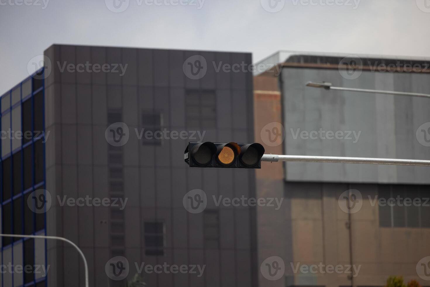 The yellow traffic light flickered, signaling to prepare for the imminent change photo