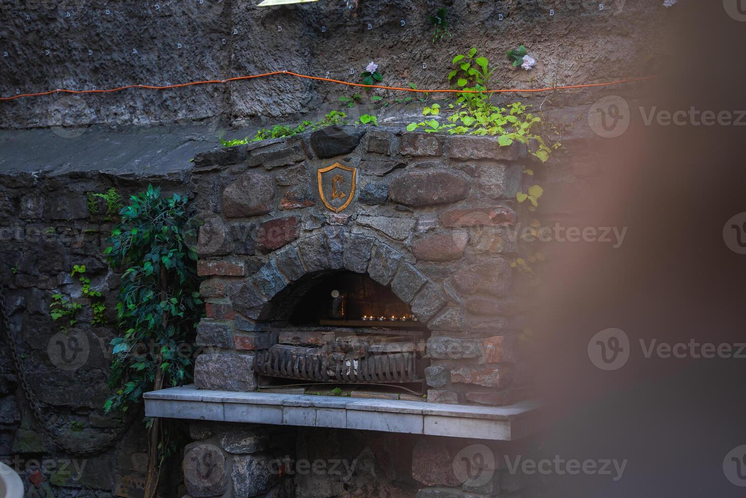 Rustic Stone Structure with Ivy and Arched Opening in Riga Old Town photo