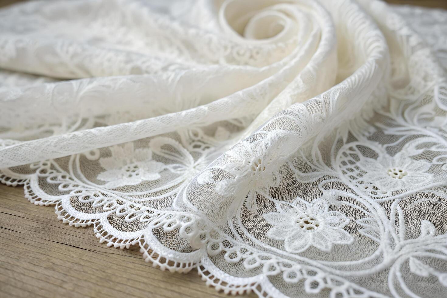 Elegant white lace fabric with intricate floral embroidery, delicate scalloped edges, and exquisite craftsmanship for luxury designs photo