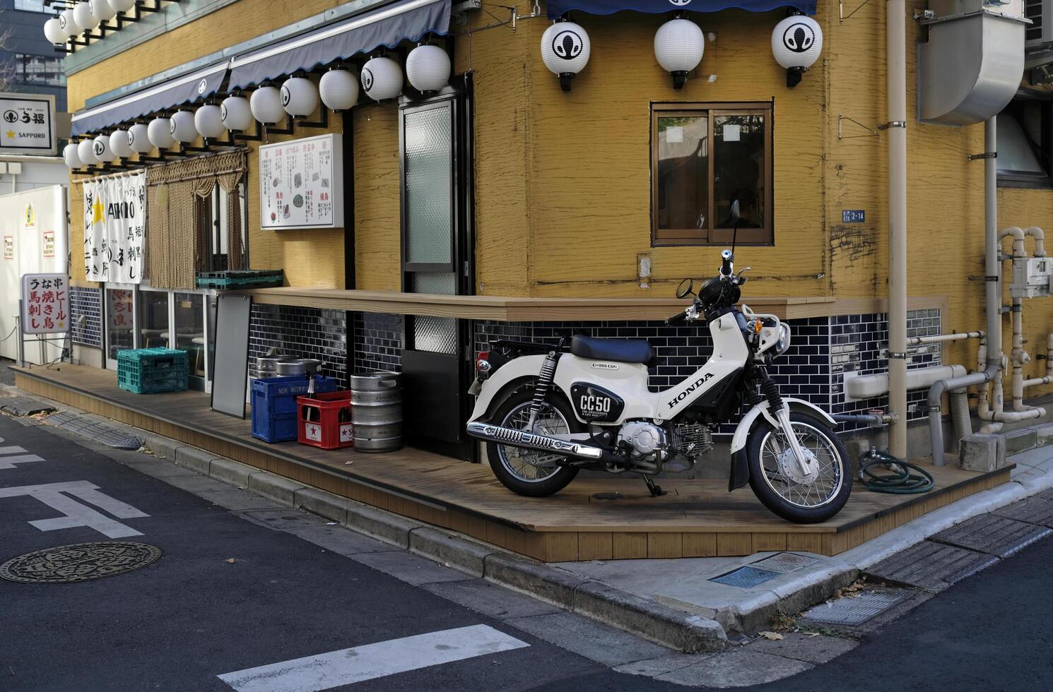 Tokyo, Japan - 12 January 2025 - A moped stands on the corner of a street in Tokyo photo