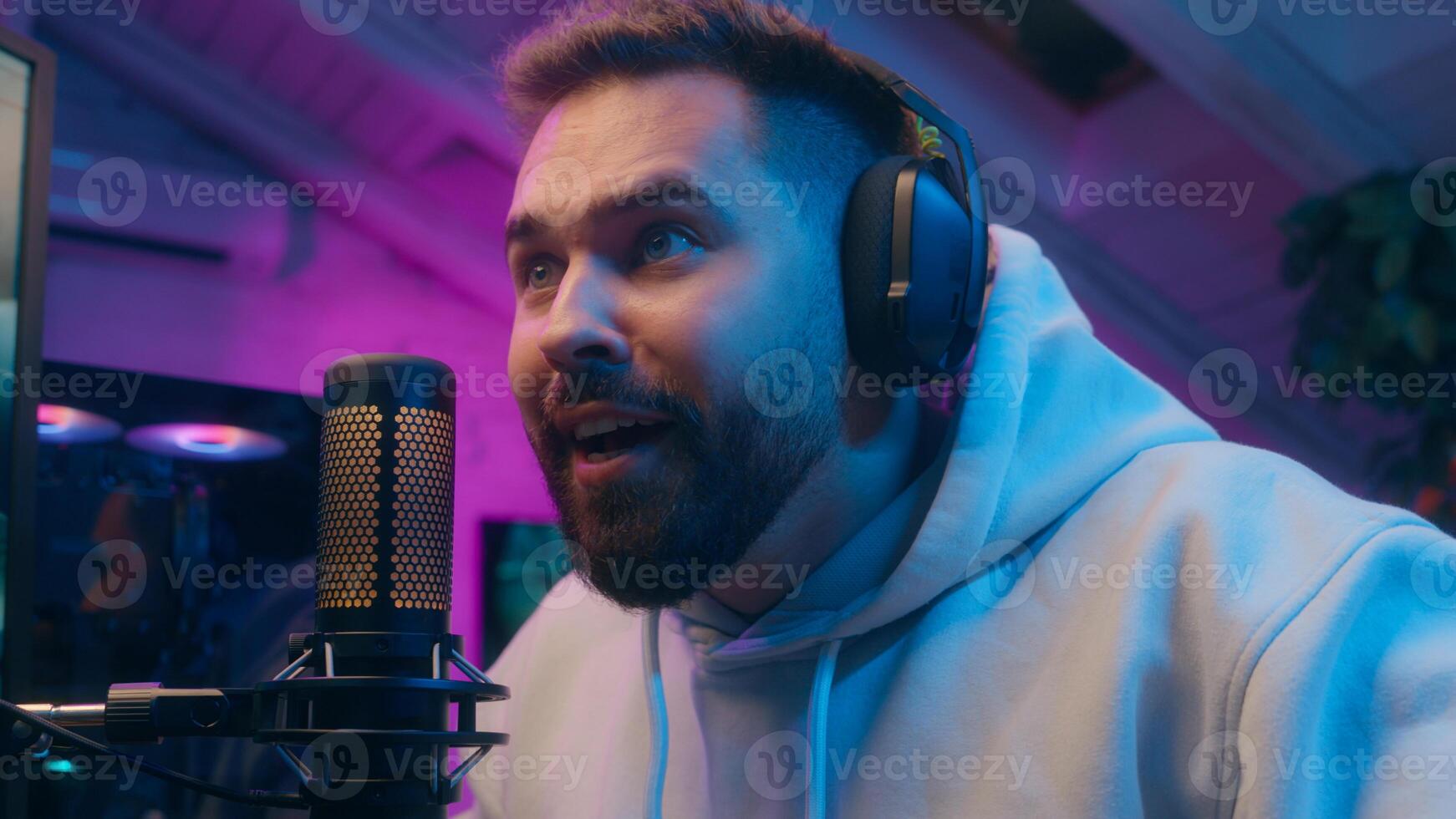 Joyful Caucasian male guy gamer streamer playing computer tech e-sport at home man winning shout winner rejoice addict influencer celebrate game victory champion receive golden cup blogger stream neon photo
