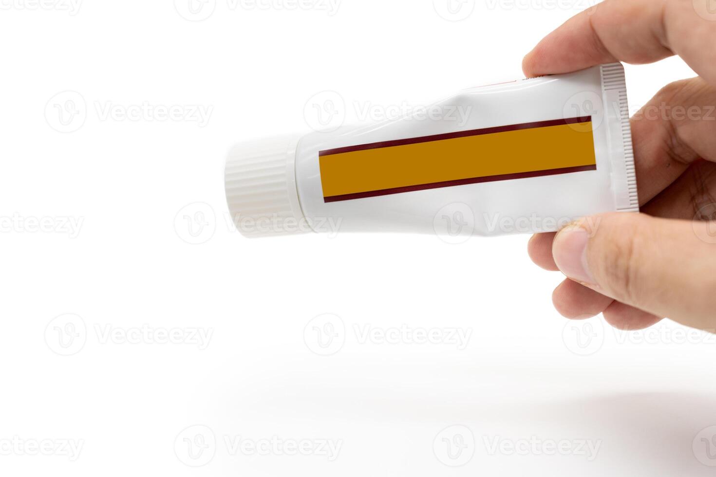 Hand Holding Blank Tube Packaging for Ointment or Cream. Mockup Concept. Skincare or Pharmaceutical Design. copy space and isolated on white background. photo