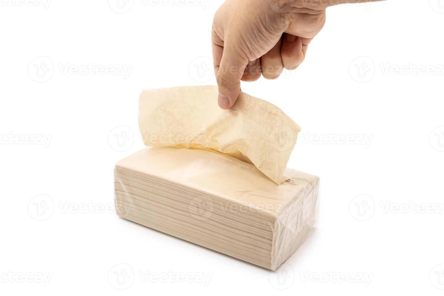 Hand taking Brown tissue paper pack isolated on white background. photo