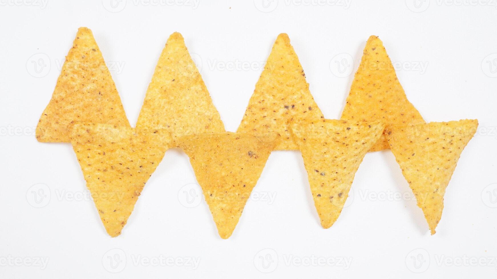 Pattern of tortilla chips isolated on white background photo