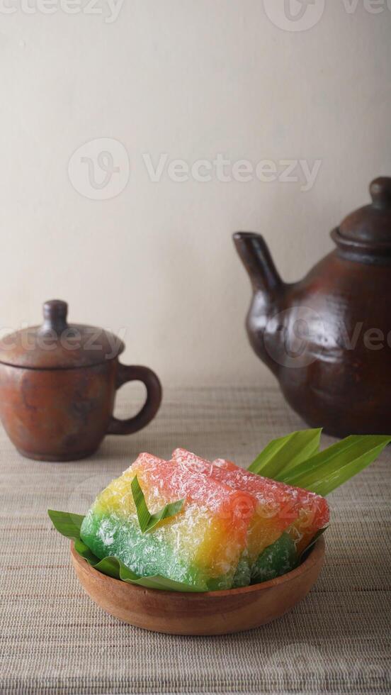 Sweet traditional Indonesian snack with chewy texture called Ongol-ongol on wooden plate photo