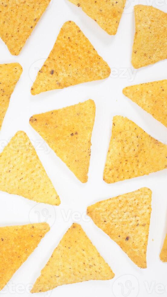 Yellow tortilla chips pattern isolated on white background photo