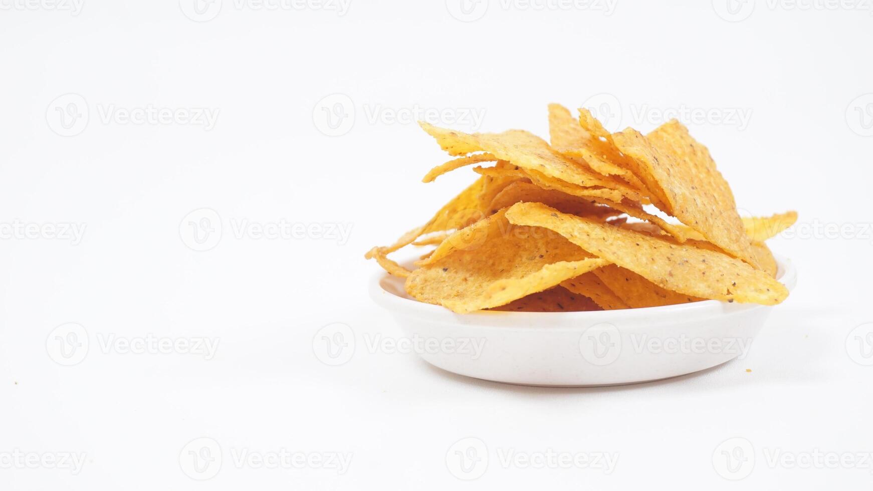Crispy tortilla chips on small plate isolated on white background photo