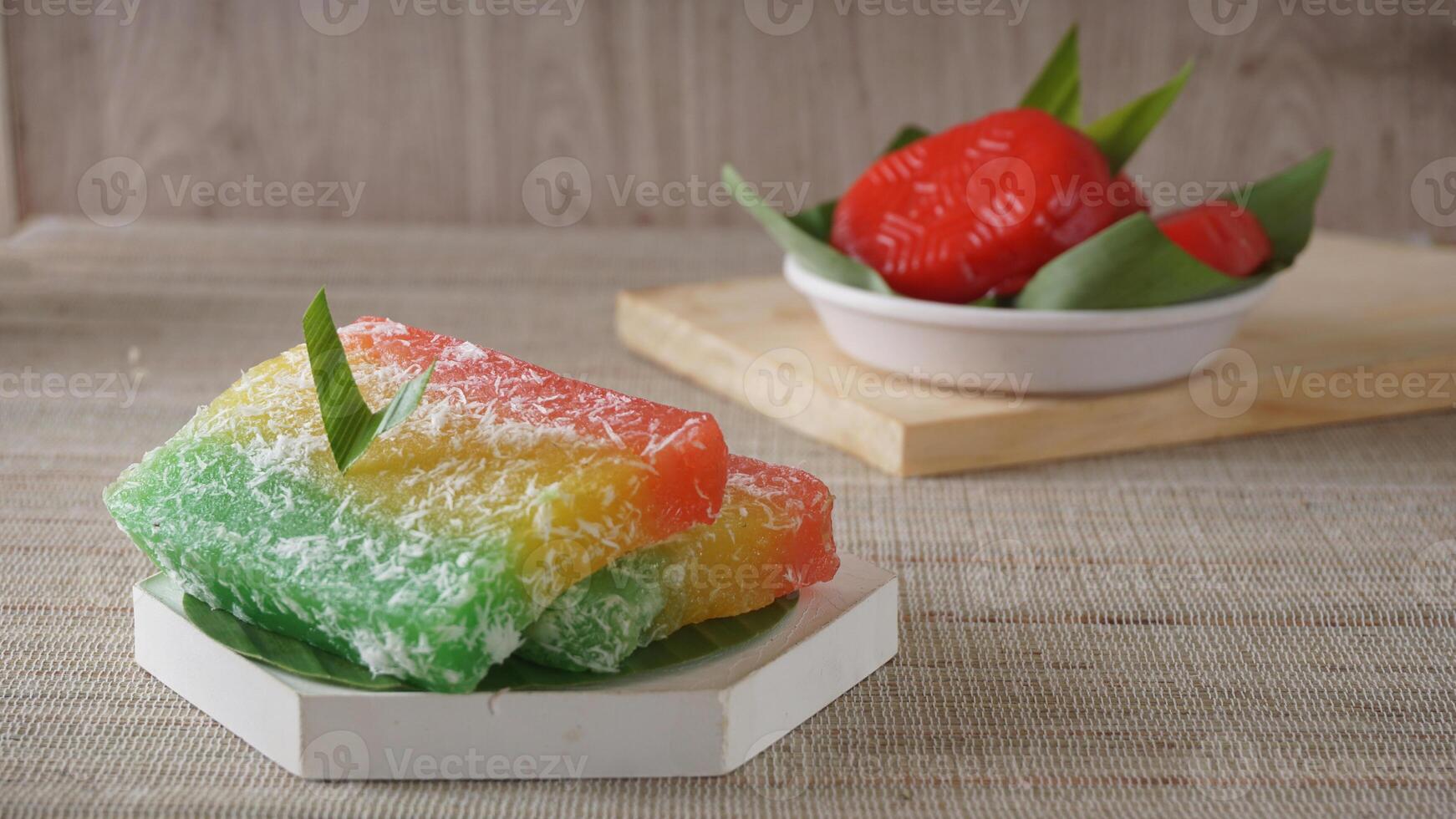Traditional Indonesian cake, Ongol-ongol or layered cassava cake and Kue Mata Kebo or buffalo eye cake on platter photo