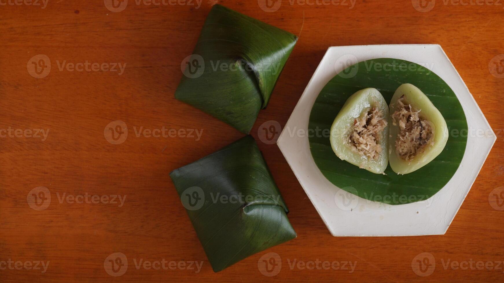 Kue Bugis, popular traditional Indonesian snack dessert made from glutinous rice flour on wooden plate photo