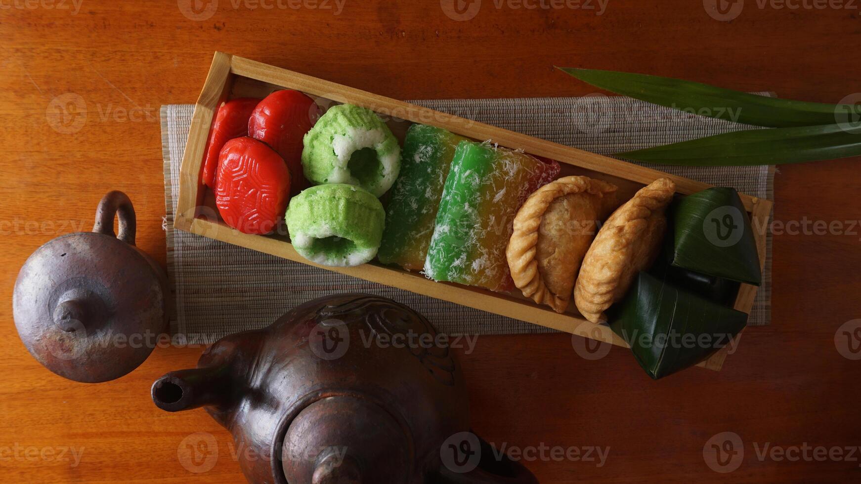 Delicious traditional market snacks from Indonesia on wooden tray photo