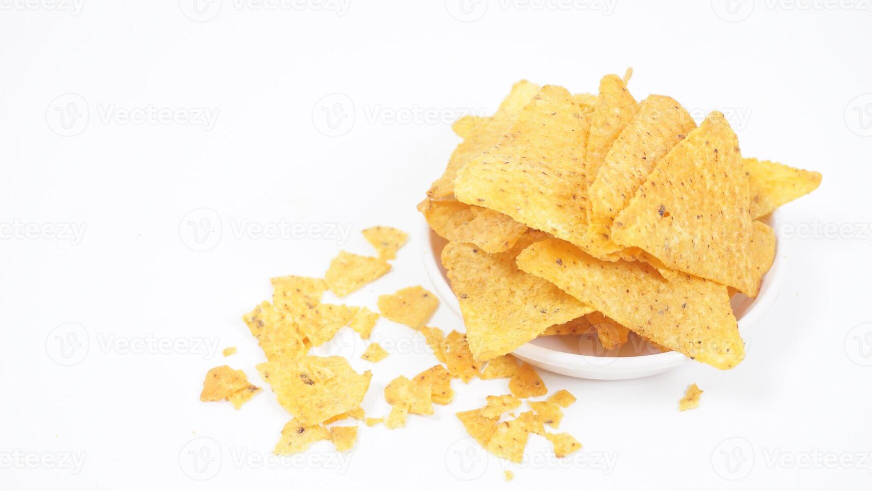 Tortilla chips on small plate whit crumbs isolated on white background photo