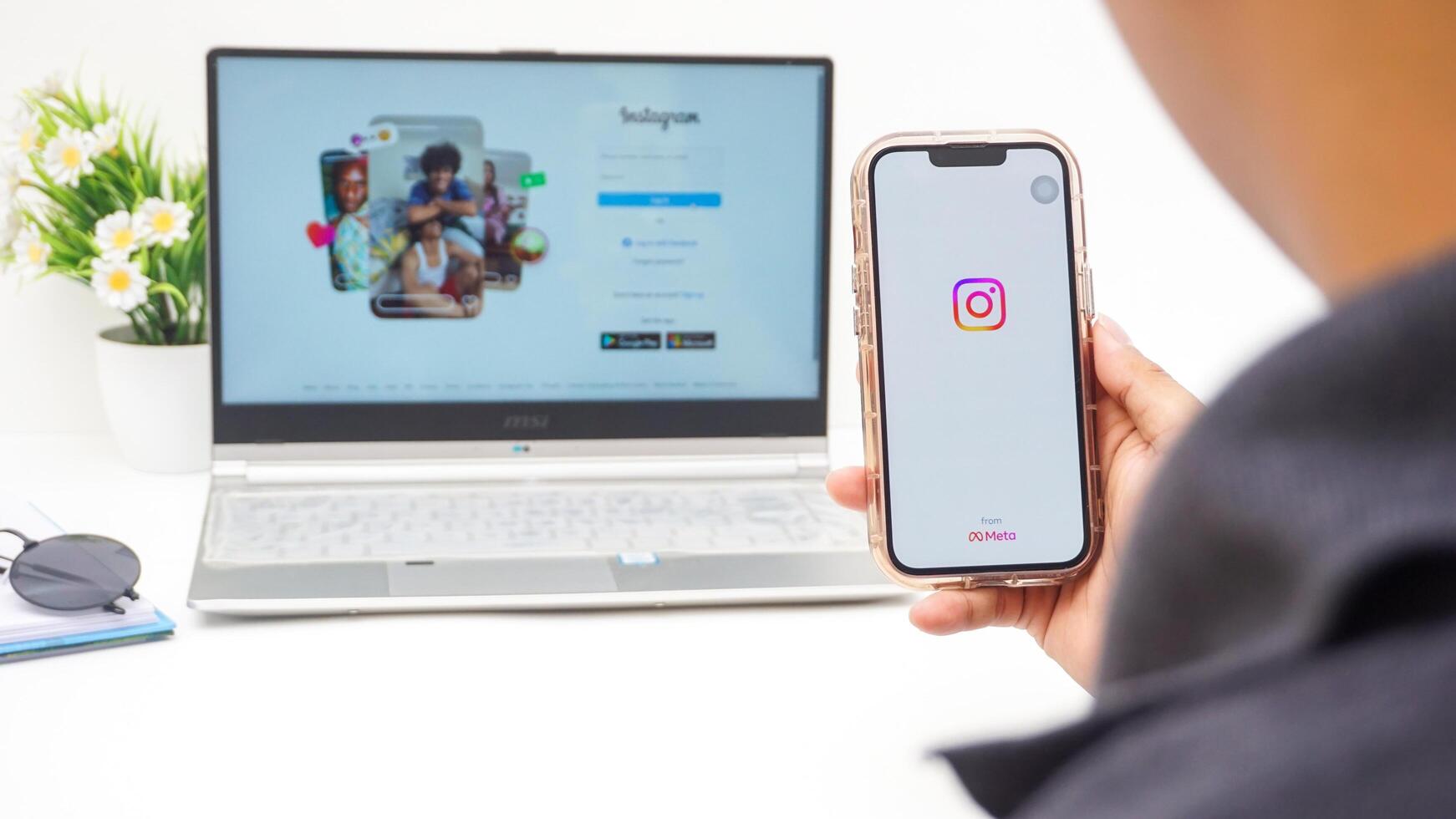 Yogyakarta, Indonesia, 2025 -Man using smartphone that shows front page of Instagram application on the screen isolated on white background photo