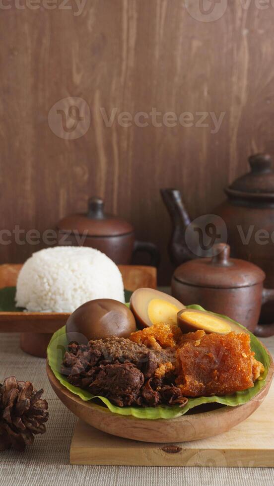 Gudeg, a traditional Javanese dish from Yogyakarta, Indonesia, made primarily from young unripe jackfruit or nangka with several side dishes and a plate of rice photo