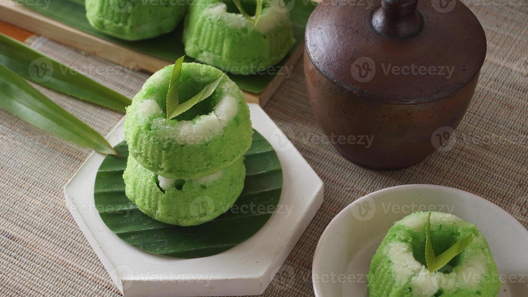 Traditional Indonesia steamed sweet cupcake with grated coconut, Kue Putu on platters photo