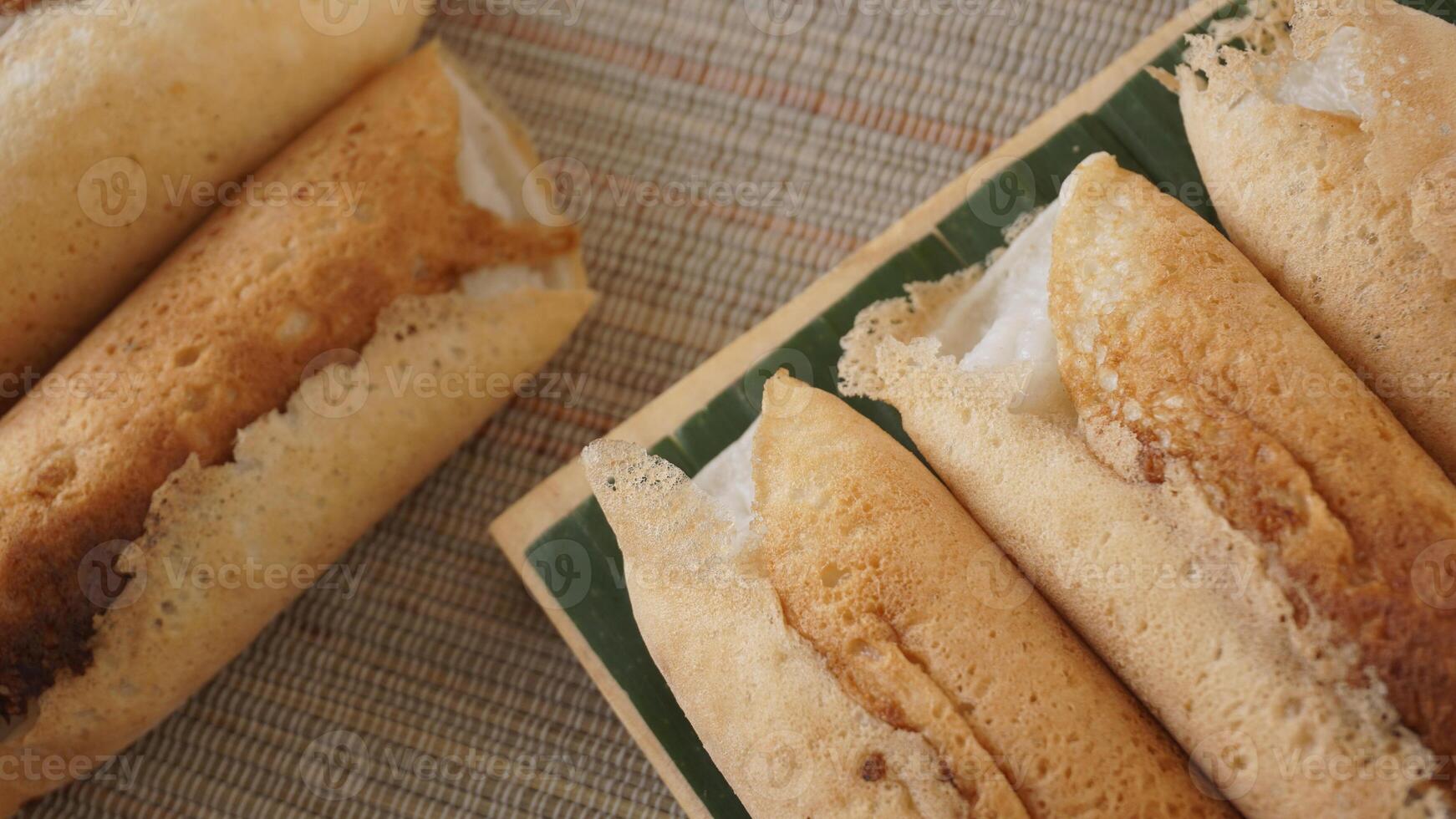 Rolled Kue Serabi, popular traditional Indonesia coconut milk pancake dessert snack photo