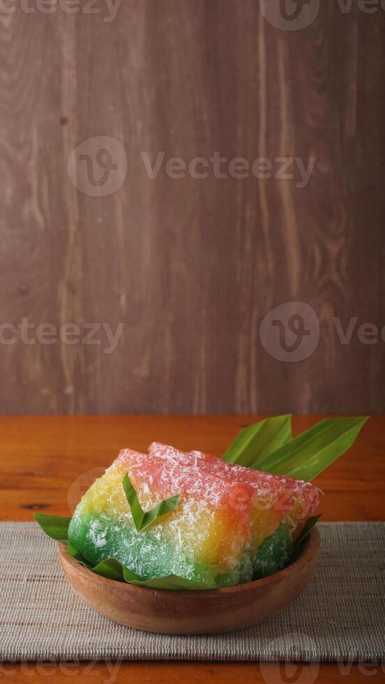 Sweet traditional Indonesian snack called Ongol-ongol on wooden plate photo