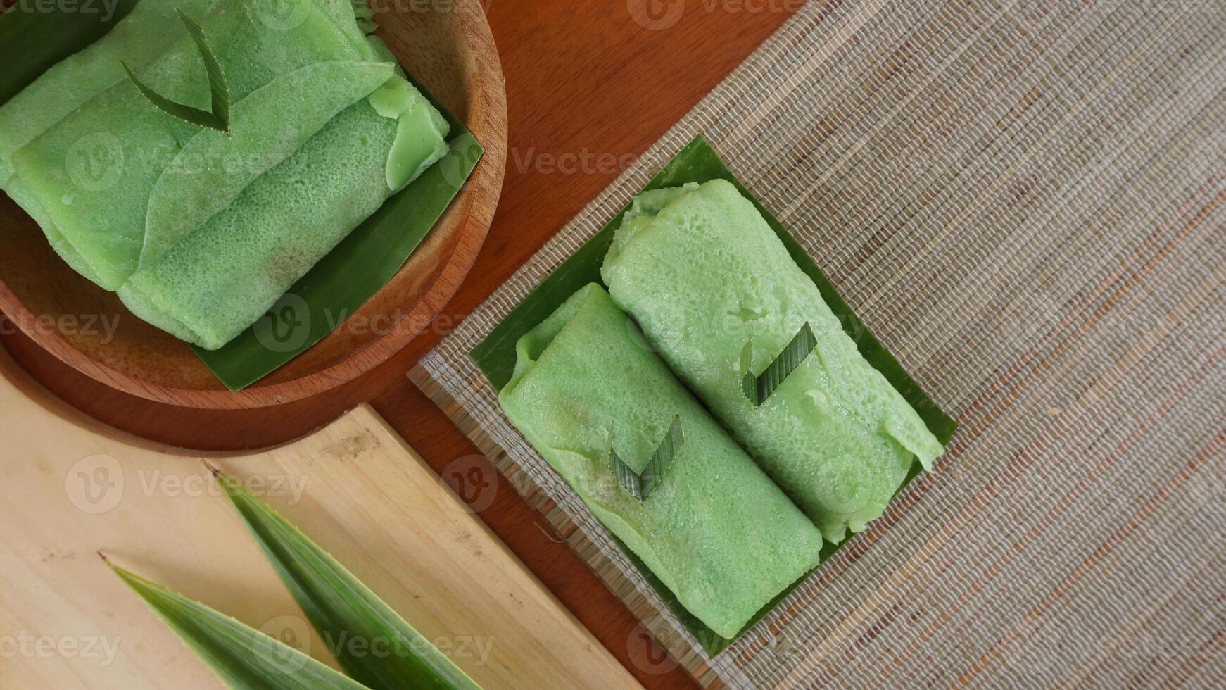 Top Dadar Gulung, traditional Indonesia sweet roll crepe on wooden platters photo