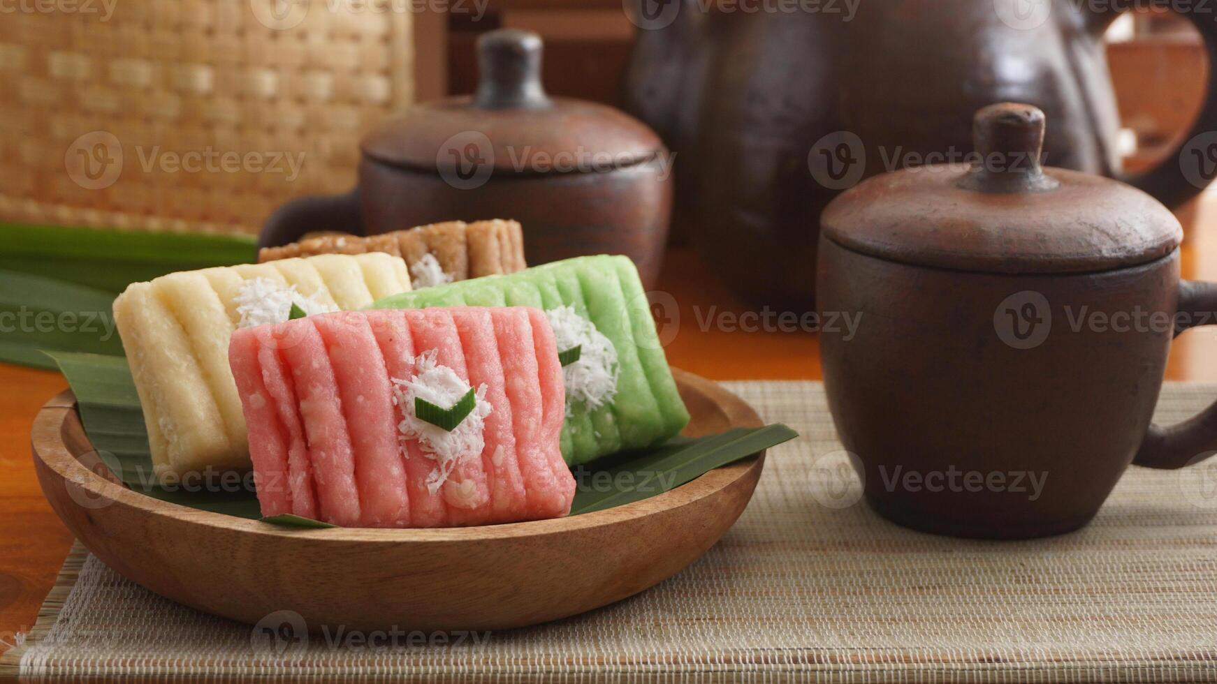 Gethuk, a traditional Indonesian snack made from steamed and mashed cassava with sugar in various colors with grated coconut topping photo