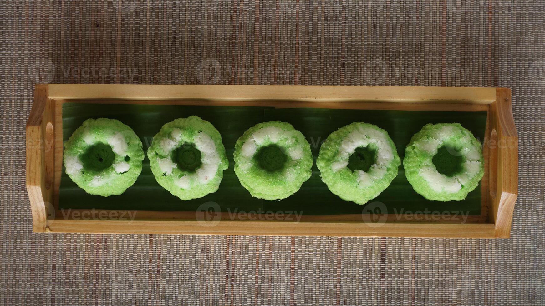 Putu Ayu, traditional Indonesia steamed cupcake with grated coconut on wooden tray photo
