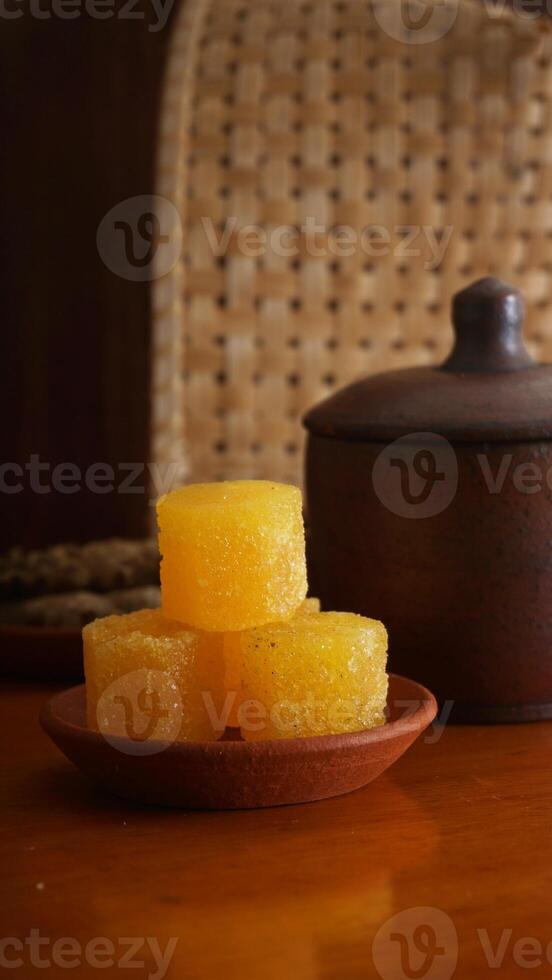 Stack of rock sugar isolated against rustic background photo