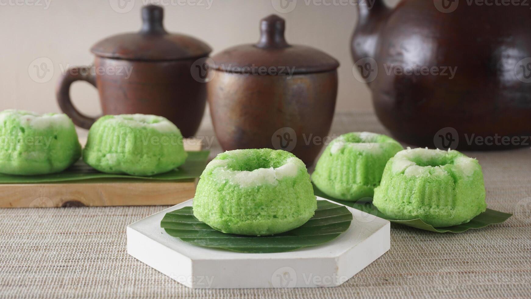 Putu Ayu, traditional Indonesia steamed sweet cupcake with grated coconut on platters photo