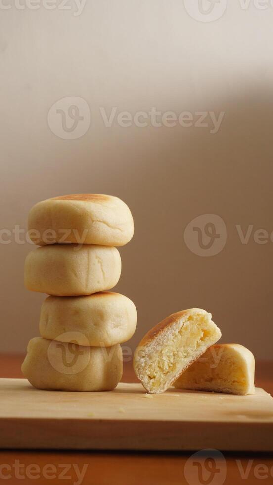 Stack of Bakpia, round pastry filled with sweet green bean paste, a specialty traditional snack from Yogyakarta, Indonesia photo