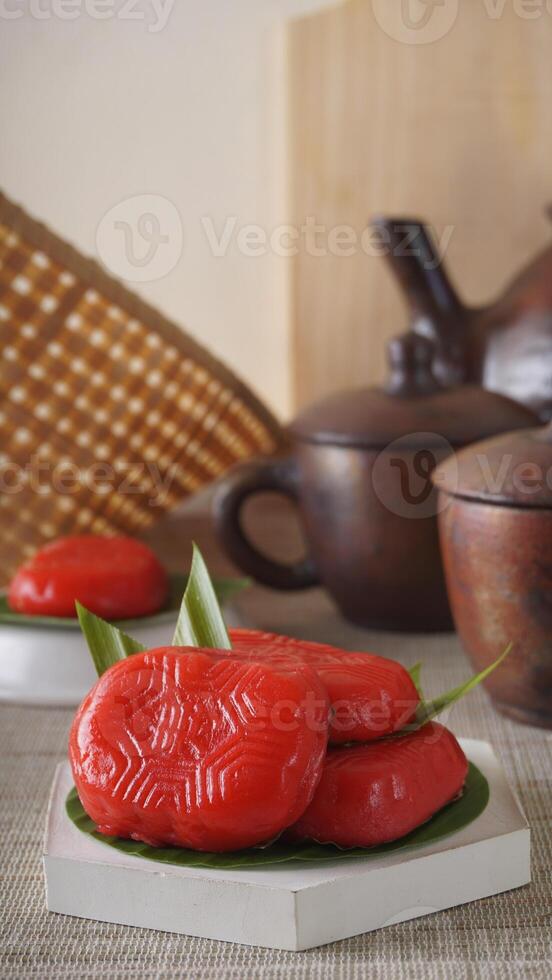 Kue Mata Kebo means buffalo eye cake, traditional Indonesian snack made from glutinous rice flour, on white platters photo
