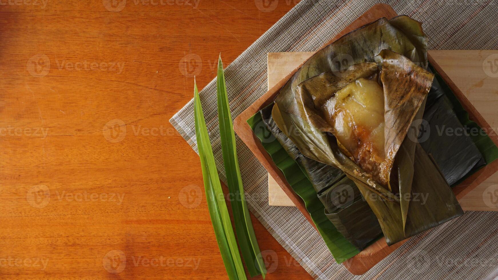 Lemet, traditional Indonesian snack made from cassava, wrapped in banana leave, and steamed photo