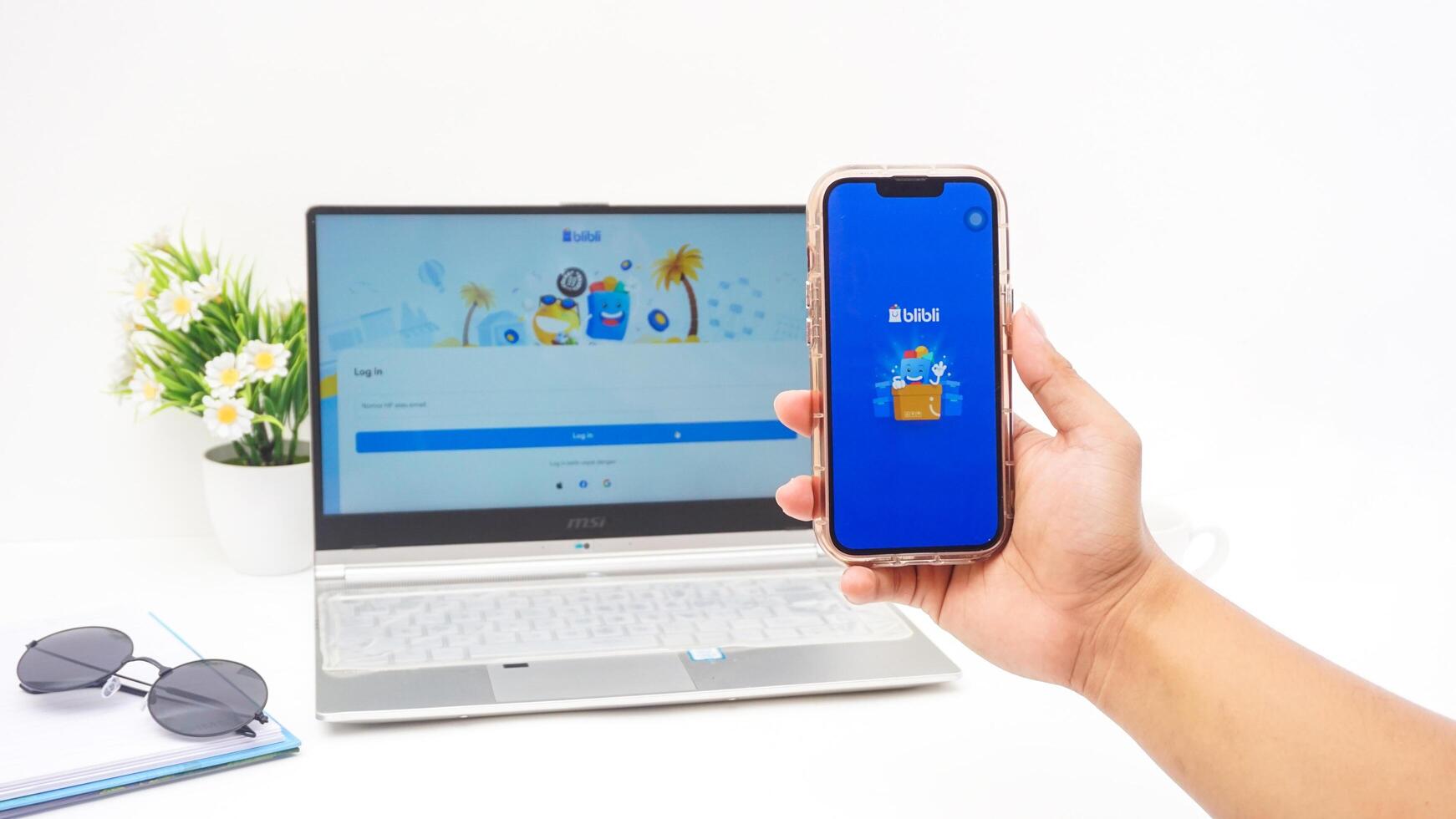 Yogyakarta, Indonesia, 2025 -Hand holding smartphone that shows opening page of Blibli, e-commerce platform from Indonesia, isolated on white background photo