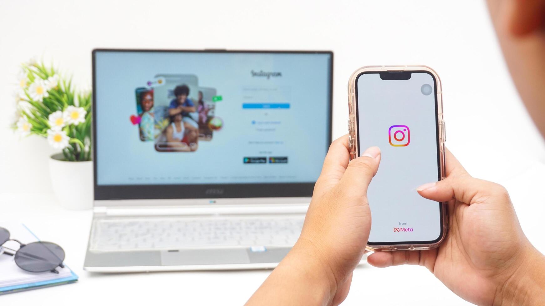 Yogyakarta, Indonesia, 2025 -Man holding smartphone that shows front page of Instagram application on the screen isolated on white background photo