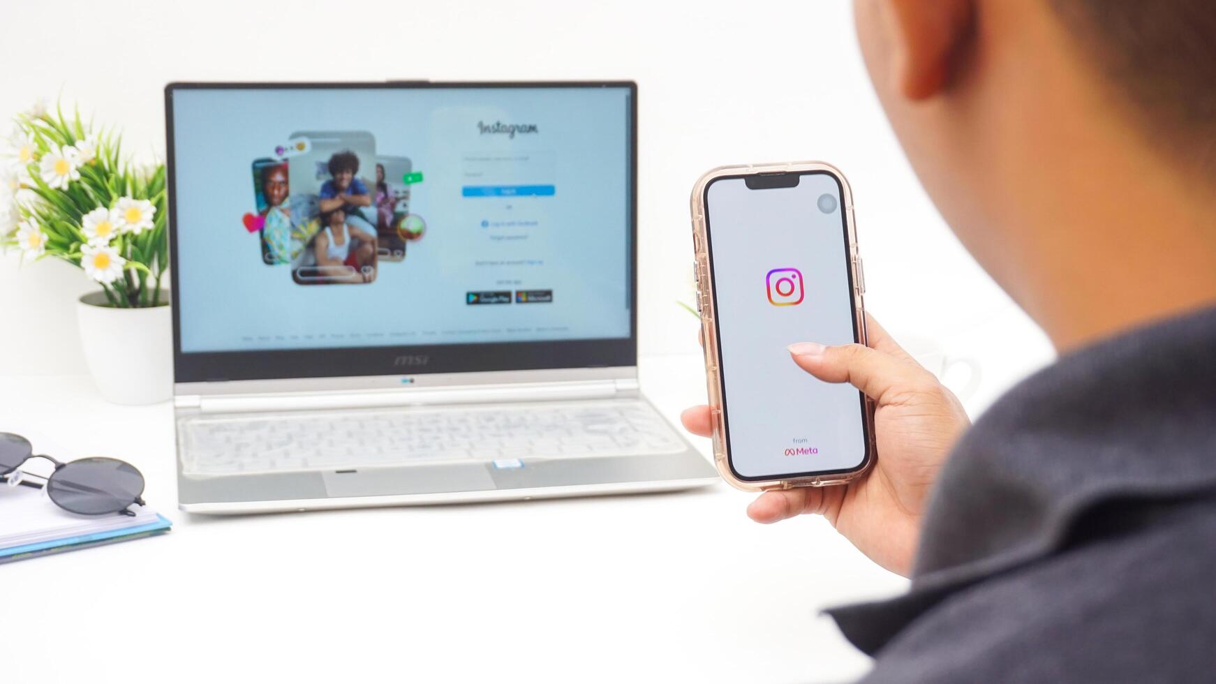 Yogyakarta, Indonesia, 2025 -Man with smartphone that shows front page of Instagram application on the screen isolated on white background photo