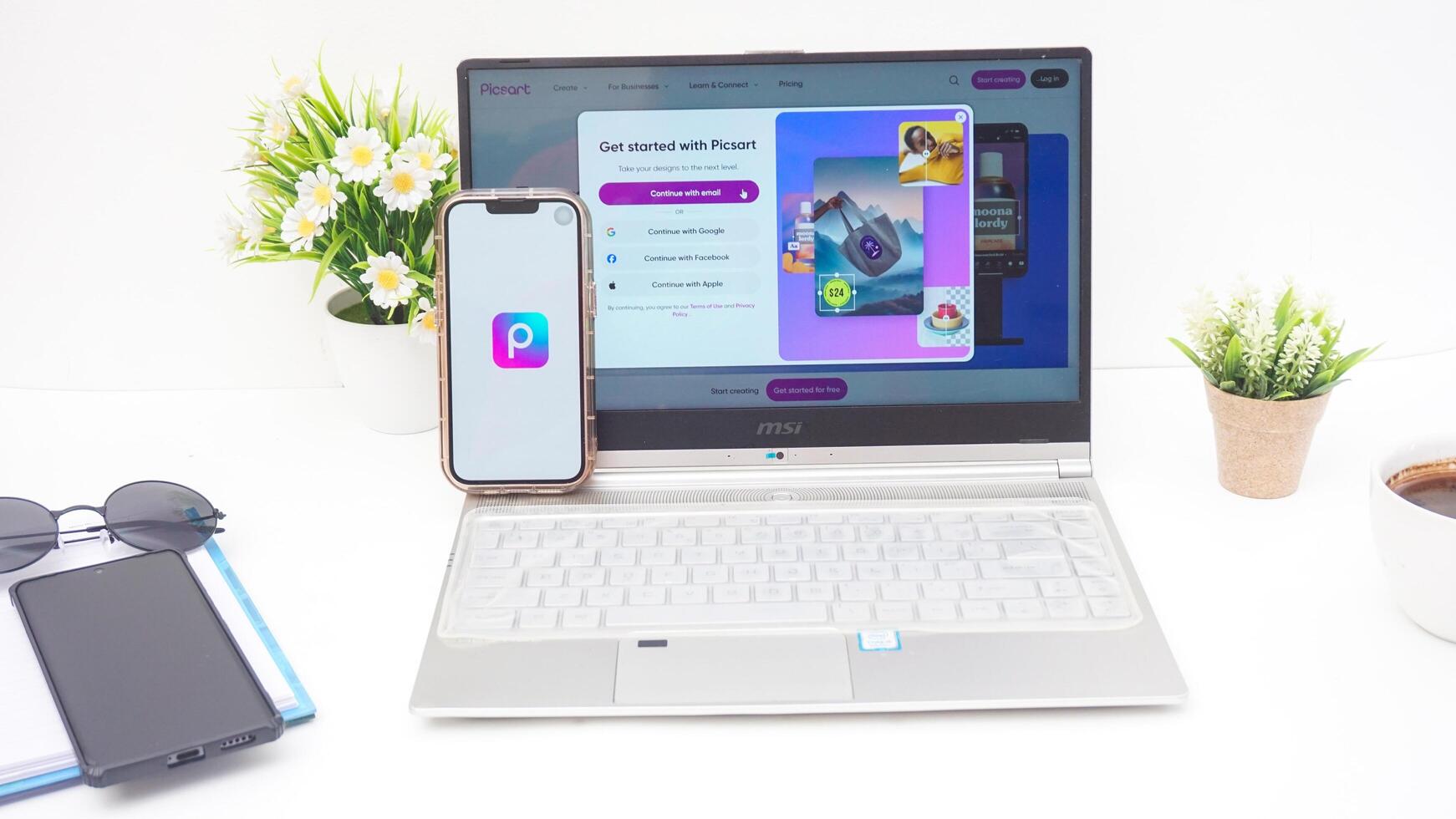 Yogyakarta, Indonesia, 2025 - Smartphone and laptop shows front page of Picsart, a creative editing platform application on the screen isolated on white background photo
