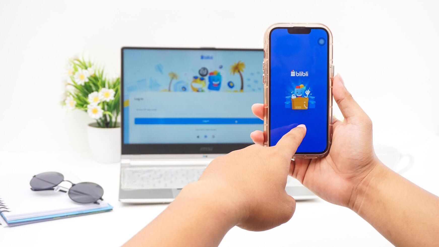 Yogyakarta, Indonesia, 2025 -Man hand with smartphone that shows opening page of Blibli, e-commerce platform from Indonesia, isolated on white background photo