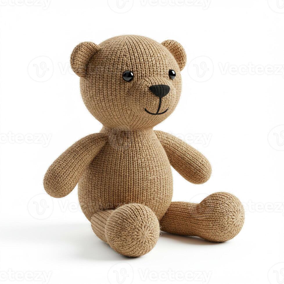 a knitted teddy bear sitting on a white surface photo