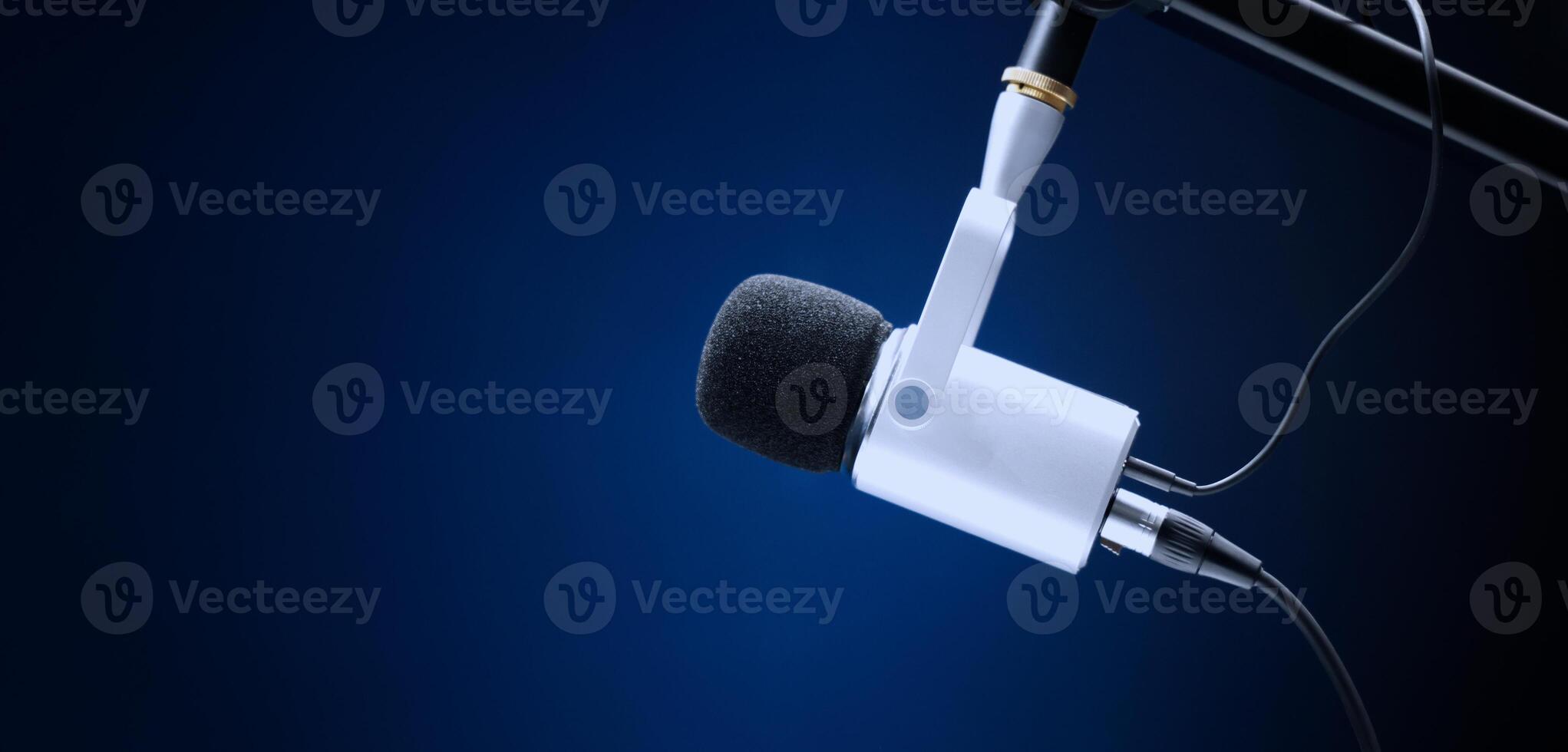 Microphone in studio. Professional studio microphone with a pop filter is suspended boom arm and studio lights. Set up mic for podcast voice over or recording high quality sound audio in a controlled. photo